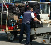 Baggage handlers lifting heavy bags